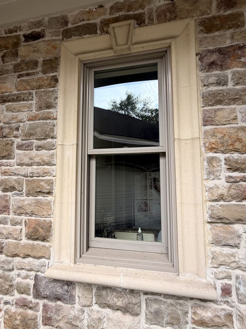 Restored window in a stone surround — frame, sill, and glass all spotless