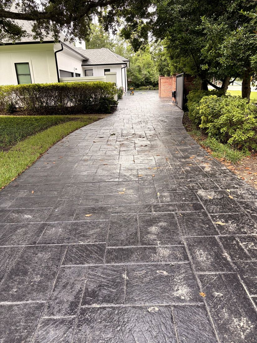 Stamped concrete driveway hazy with buildup before cleaning and sealing