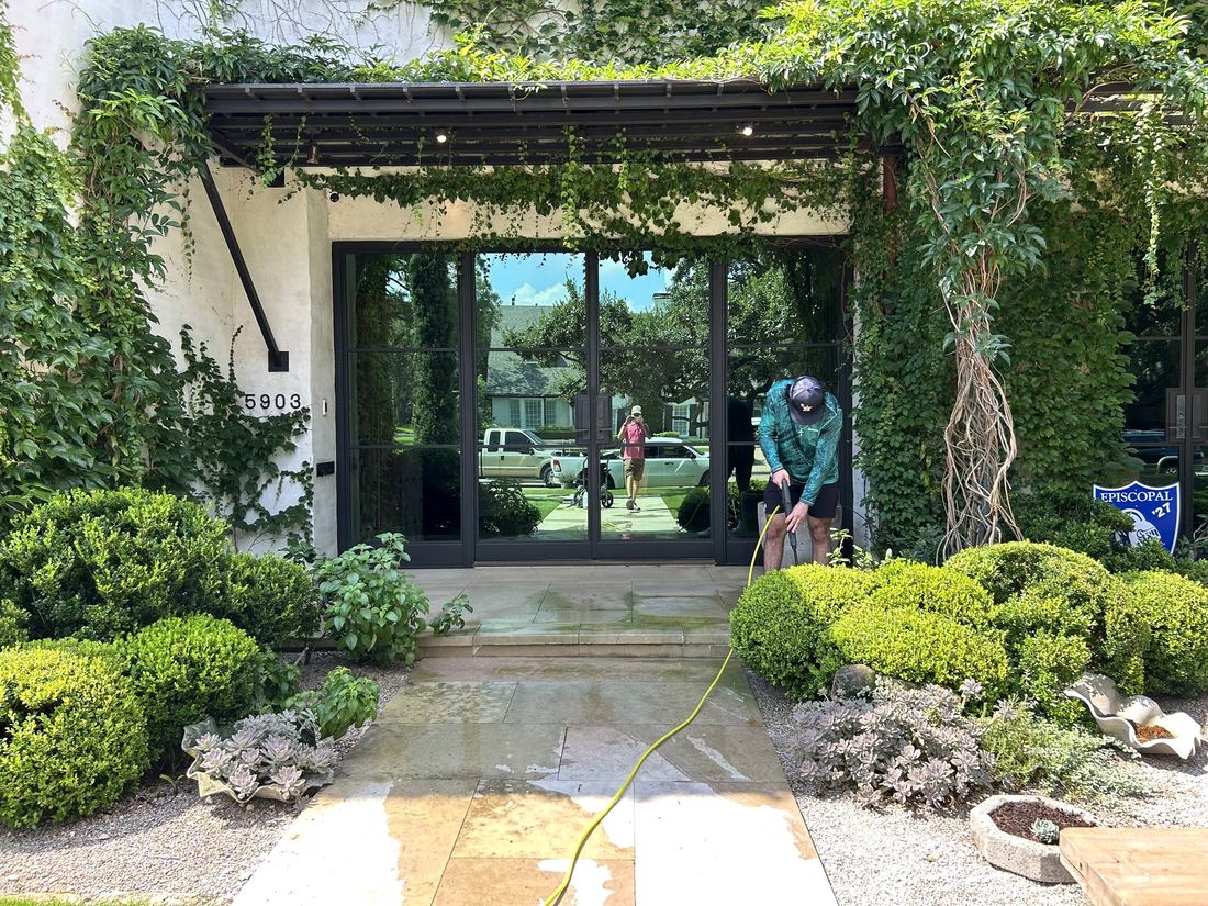 Our crew washing the stone entry of an ivy-covered Houston home