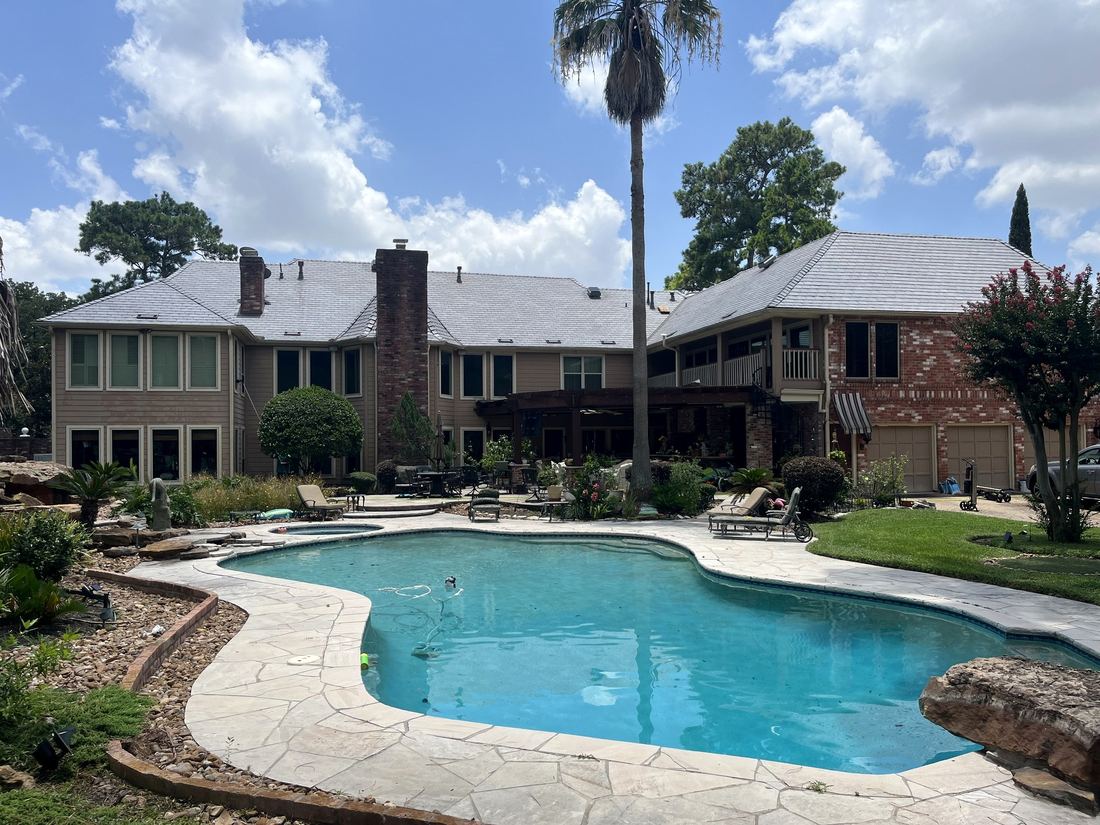 Houston estate with a freshly cleaned roofline over the backyard pool
